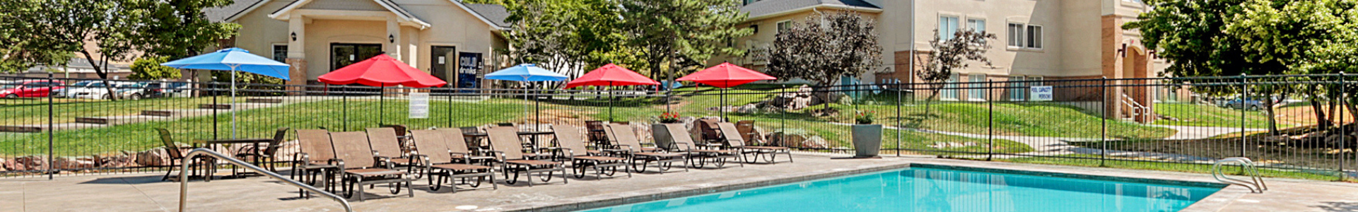 Pool with umbrella-covered lounge chairs